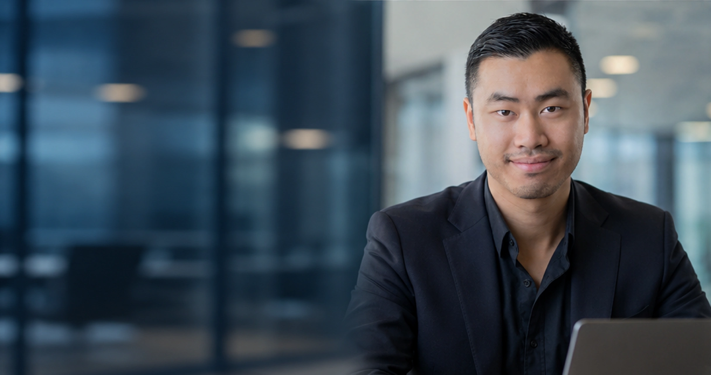 Kevin Teng seated in an office, wearing a navy blazer.