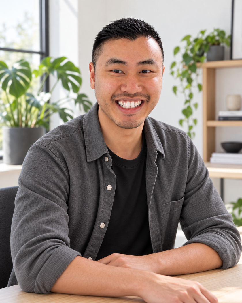 Kevin Teng in a studio setting with green plants.